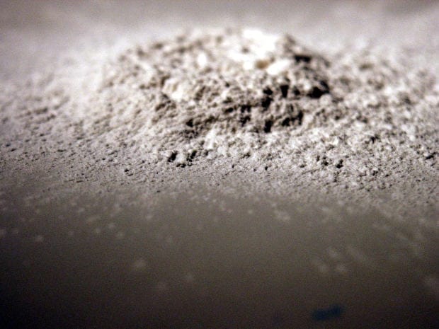 Talcum Powder Containing Asbestos - Ferraro Law Firm Close-up of a pile of talc powder, symbolizing asbestos contamination and lawsuits against BASF after acquiring Engelhard.