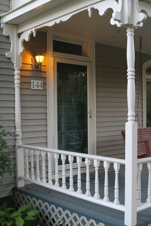 Front Porch of Residential Home - Ferraro Law Firm Front porch of a home with a lit porch light and decorative white railing, symbolizing a residential setting in an asbestos exposure case.