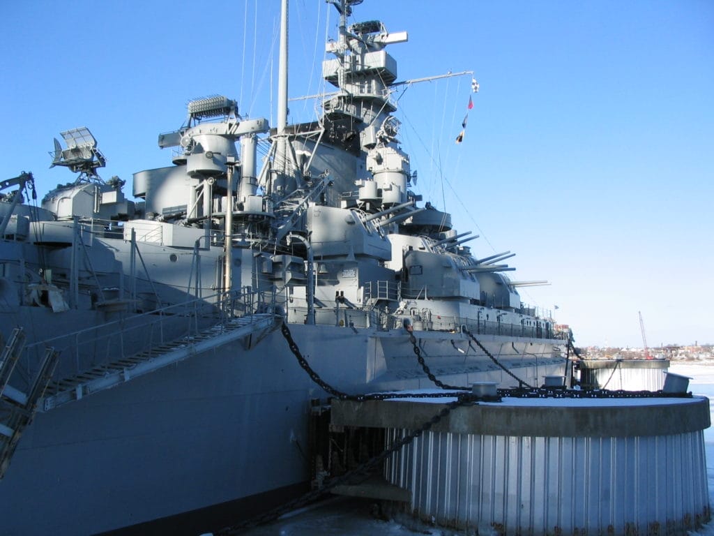Navy Battleship – Asbestos Exposure Risk for Veterans - Ferraro Law Firm Large U.S. Navy battleship docked at port, representing potential asbestos exposure risks for shipyard workers and veterans.