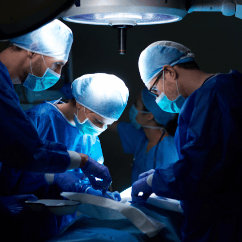Surgical team performing an operation under bright operating room lights, illustrating the complexity of medical procedures and the challenges in proving malpractice.